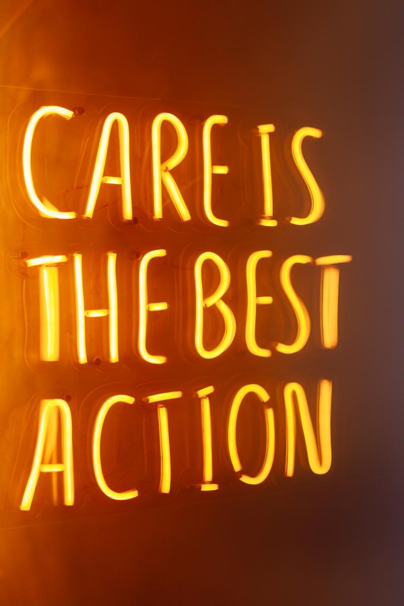 "Care is the best action" in neon lights